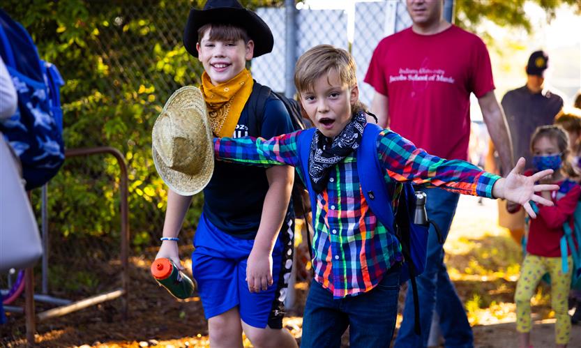 Students wearing western wear walk to school
